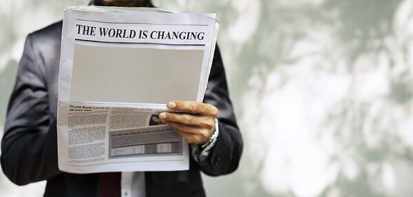 businessman reading newspaper - the world is changing